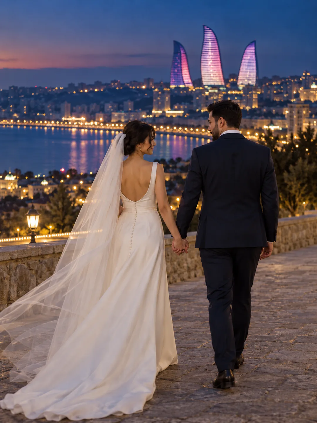 Mavi saatda Flame Towers fonunda əl-ələ addımlayan Elnarə və Taleh